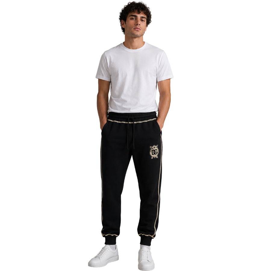 Dolce & Gabbana – black sweatpants with gold piping – full-length front view worn by model