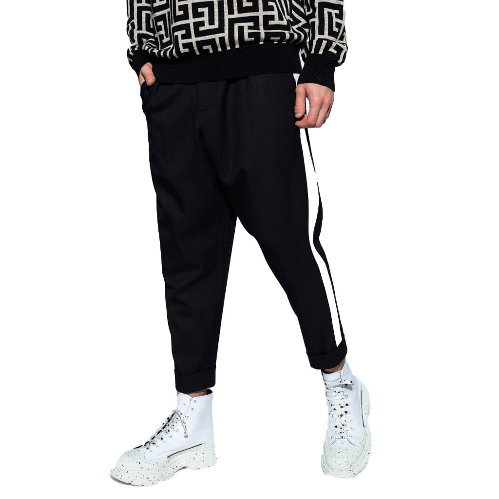 Balmain – black cotton trousers – front view worn with contrasting side stripe