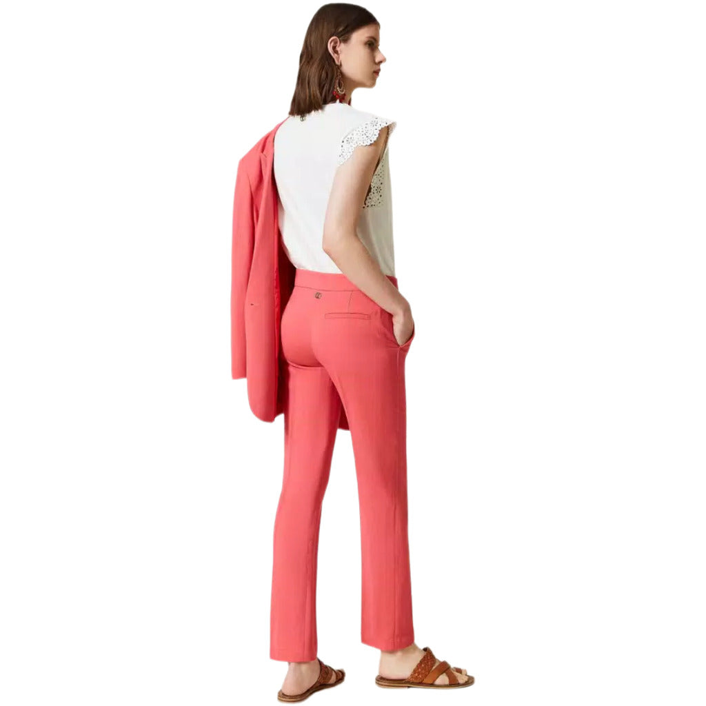 Twinset – pink cigarette trousers – rear three-quarter view worn with blazer draped over shoulder