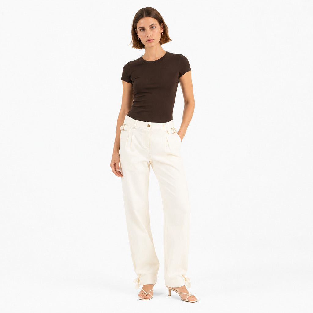 Pinko – beige wide-leg trousers – front view on model with brown top and heeled sandals