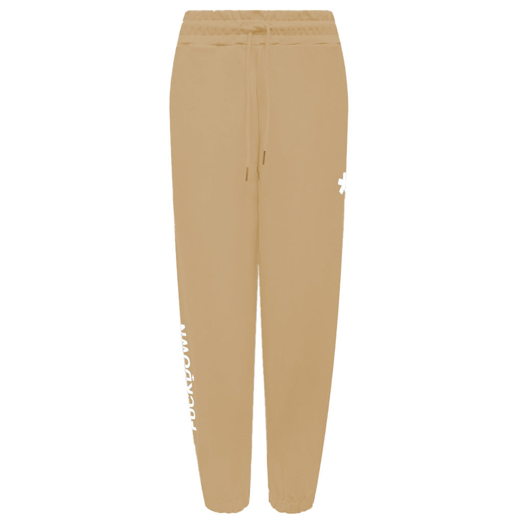 Comme Des Fuckdown – Printed Fleece Pants – Flat front view in tan with drawstring and printed logos