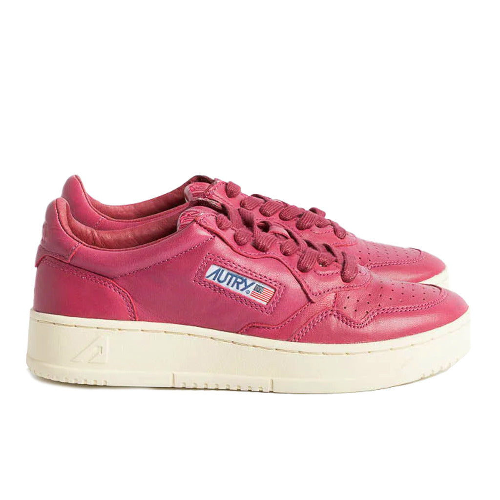 Autry – Dallas sneakers – Fuchsia pair in side view with cream soles and logo patch