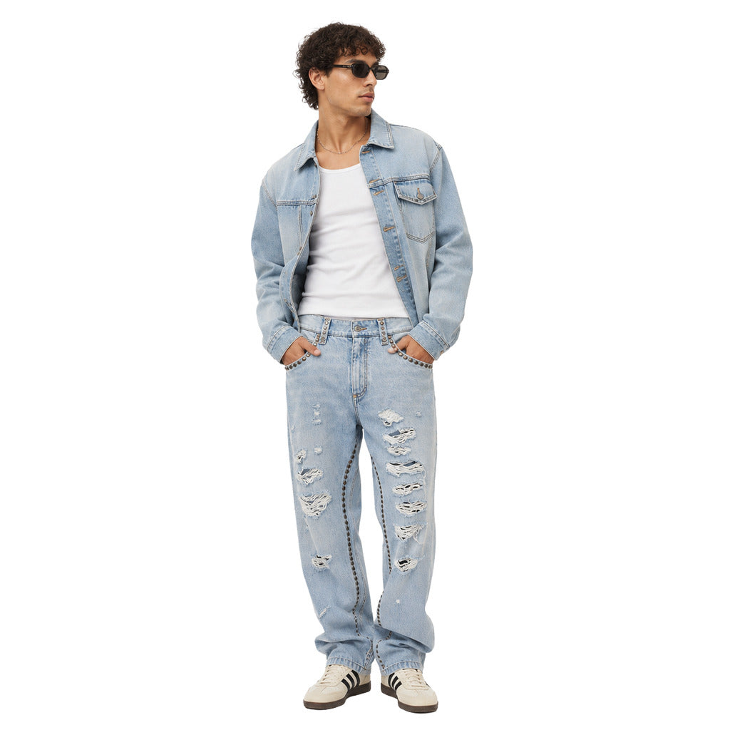 Dolce & Gabbana – light blue studded denim trousers – front view worn with a denim jacket