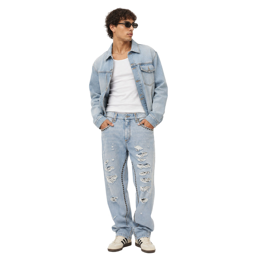 Dolce & Gabbana – light blue studded denim trousers – front view worn with a denim jacket