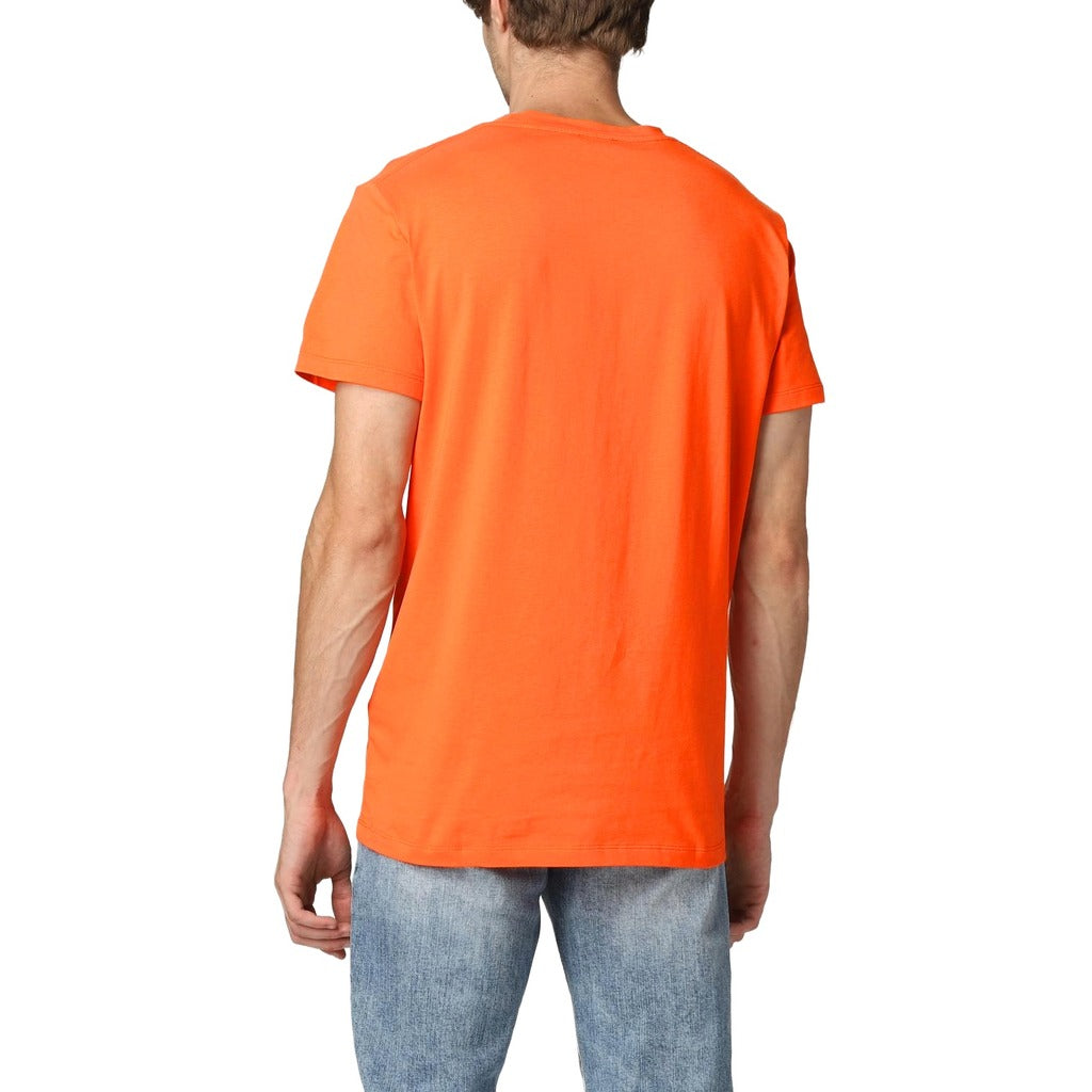 Balmain – orange short-sleeve T-shirt – plain back view worn with jeans