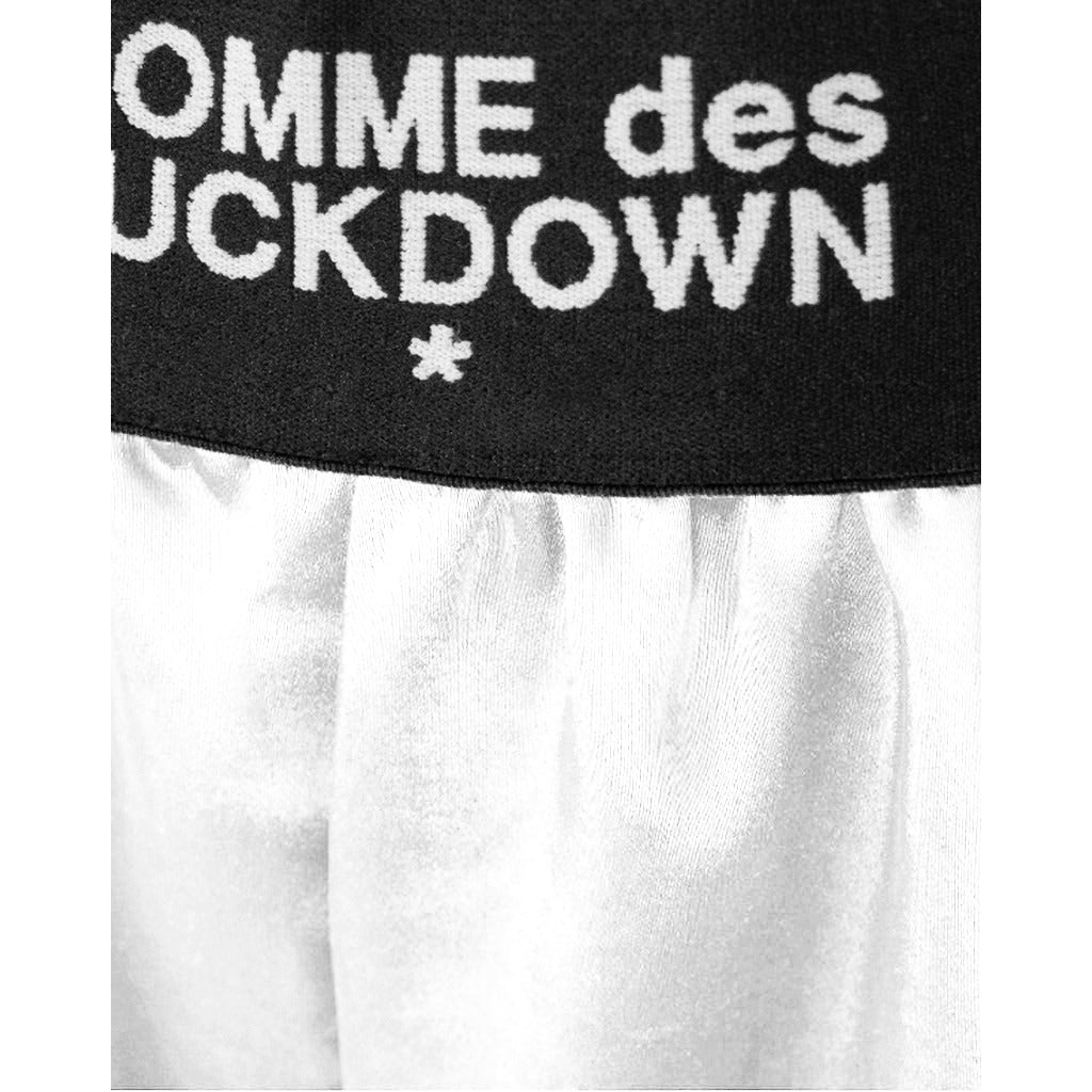 Comme Des Fuckdown – white modal shorts – close-up of logoed black waistband and white fabric