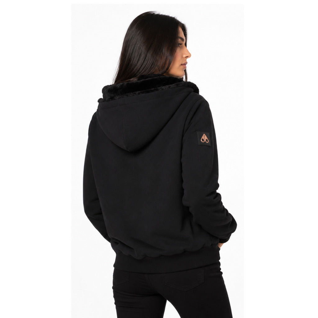 Moose Knuckles – black fleece-lined hoodie – worn back three-quarter view with sleeve patch