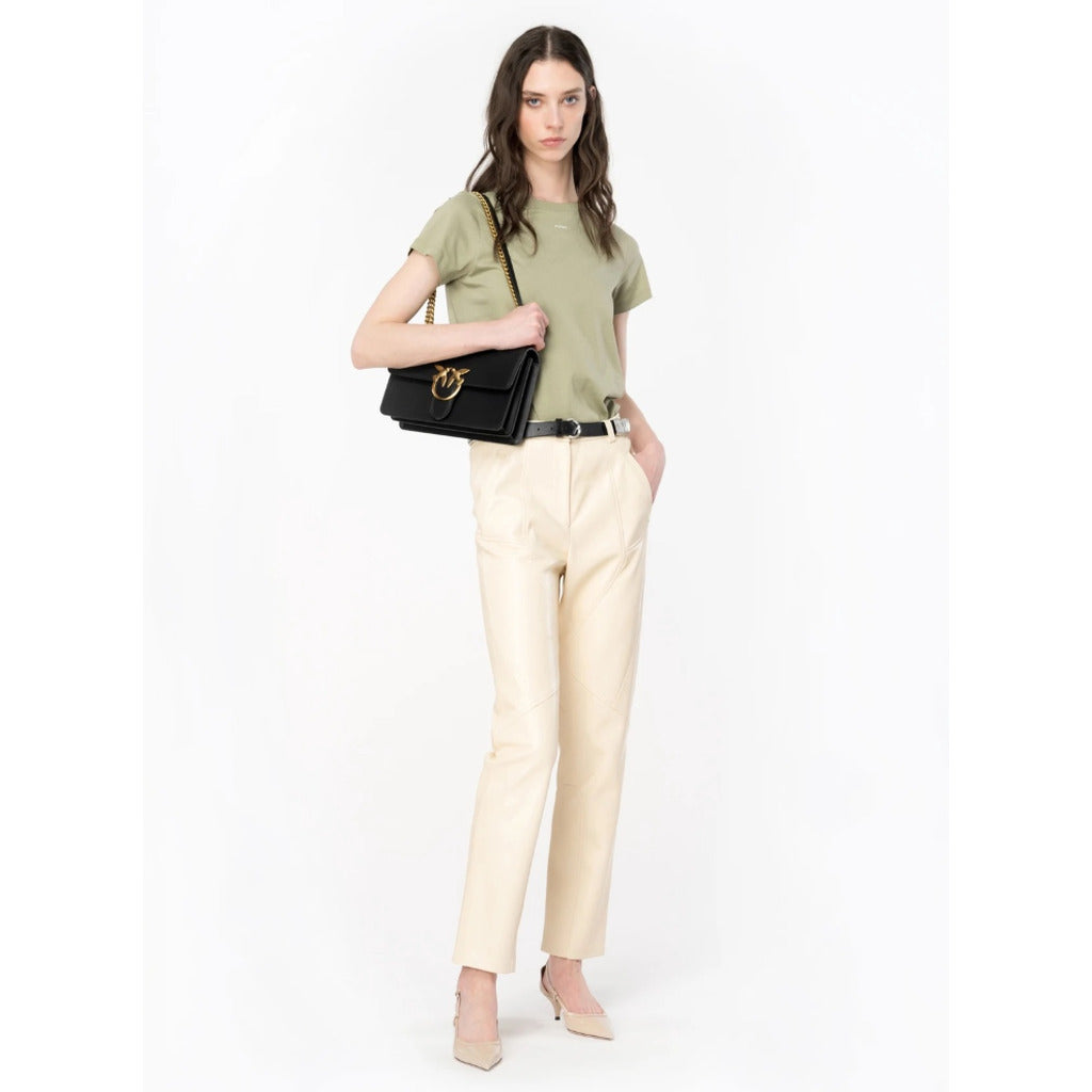 Pinko – beige faux leather trousers – model wearing them with a green top