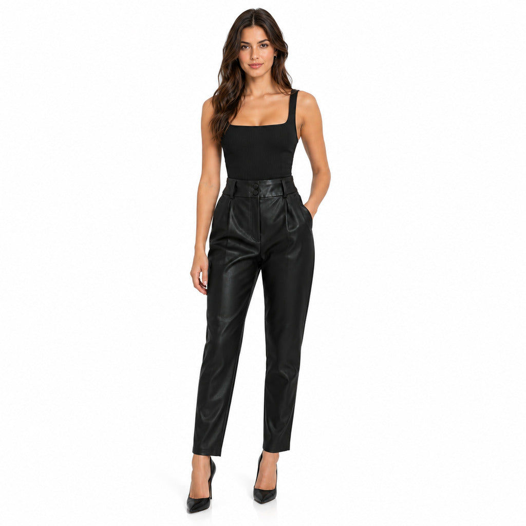 Dolce & Gabbana – black glossy trousers – model wearing them, front view with tapered legs
