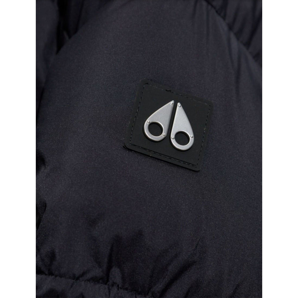 Moose Knuckles – Agate Puffer Jacket – Close-up of black fabric and silver logo patch