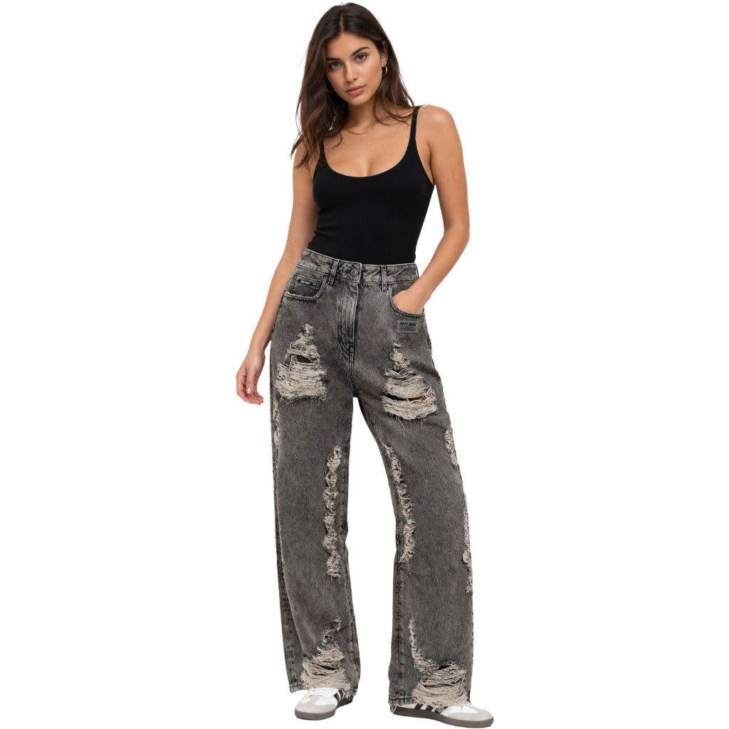 Fifty Made – black distressed jeans – model wearing the jeans with a black tank top