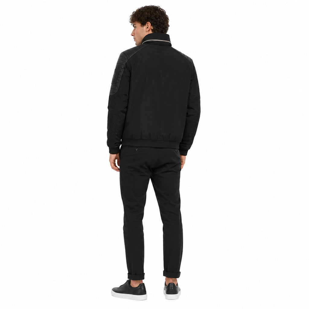 Moose Knuckles – Saint-Michel black jacket – model wearing back view with ribbed hem